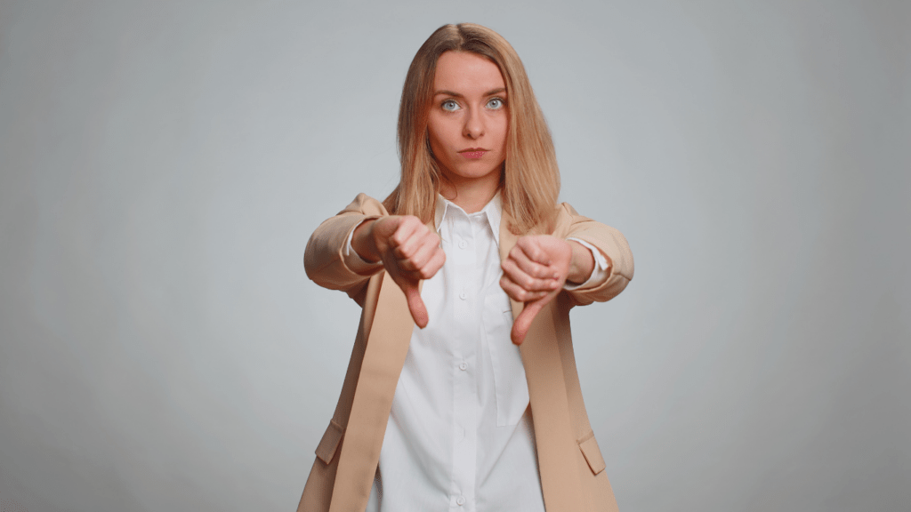 a woman showing thumbs down as a rating